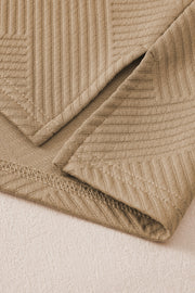 Tan textured polo set culottes with wide legs and subtle chevron pattern detail.
