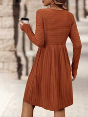 Ribbed knit A-line dress with long sleeves in rust, featuring a fitted bodice and flared skirt.