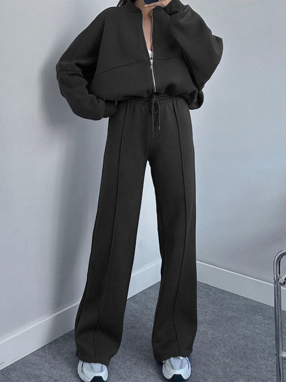 Black zip-up hoodie and wide-leg sweatpants set with drawstring waist and front seam detail