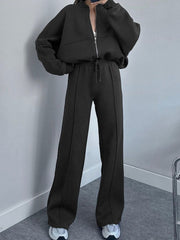 Black zip-up hoodie and wide-leg sweatpants set with drawstring waist and front seam detail