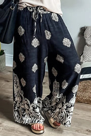 Black palazzo trousers with damask print and drawstring waist.