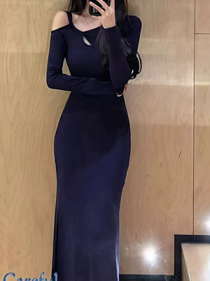 Navy long sleeve asymmetrical cutout maxi dress with a thigh slit.