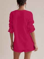 Textured cotton pajama set in cerise, featuring a long sleeve button-up top and shorts.