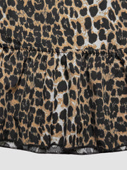 Leopard print cropped cami top with a ruffled hem and back tie detail.