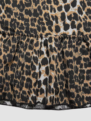 Leopard print cropped cami top with a ruffled hem and back tie detail.