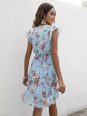 Light blue floral pleated dress with ruffle sleeves and a belted waist.