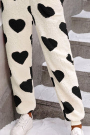 Heart-print sherpa onesie pants in cream with black hearts, cuffed ankles