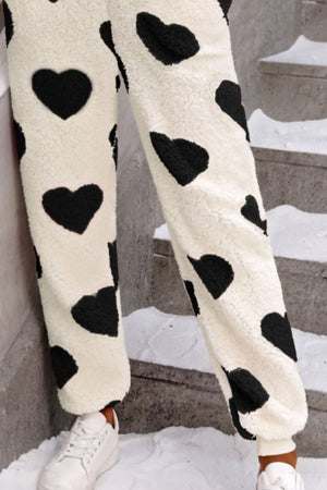 Heart-print sherpa onesie pants in cream with black hearts, cuffed ankles