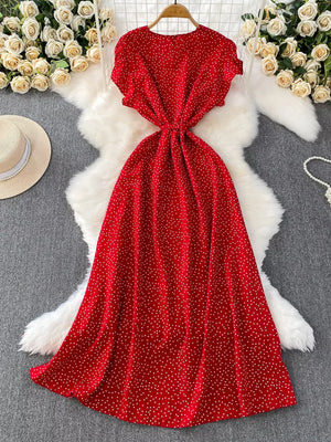 Red polka dot maxi dress with belt, short sleeves, and button front.