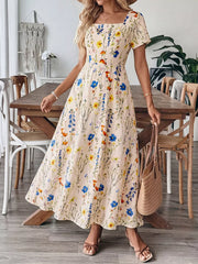 A-line maxi dress with square neckline and short sleeves in a cream floral print.