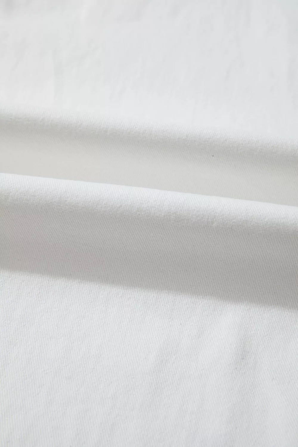 White denim casual wide-leg jeans showing fabric texture