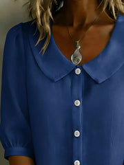 Peacock blue button-down shirt with puff sleeves and Peter Pan collar.