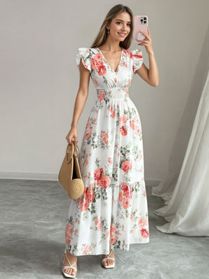 White floral maxi dress with ruffle sleeves, V-neck, and smocked waist.