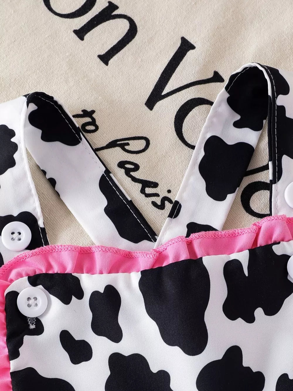 Children's Cow Print Ruffle Jumpsuit in Brown And White, close-up detail