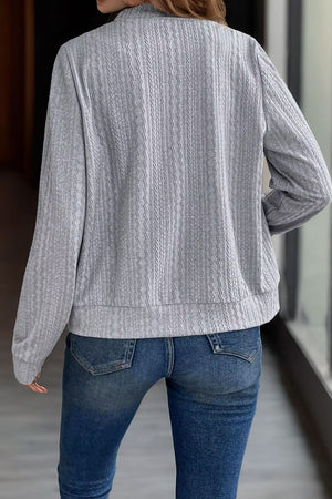 Gray textured ribbed bomber jacket with a casual fit and long sleeves.