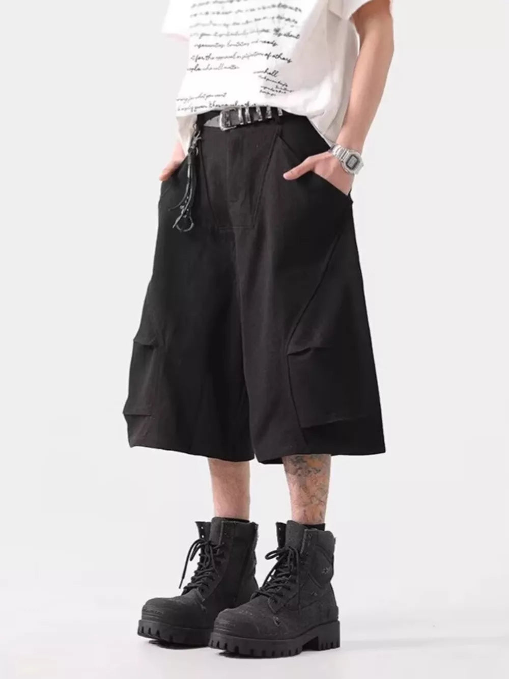 Black relaxed fit cargo cropped pants with multiple pockets and a chain detail.