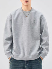 Gray sweatshirt with crew neck, long sleeves, and embroidered dinosaur detail.