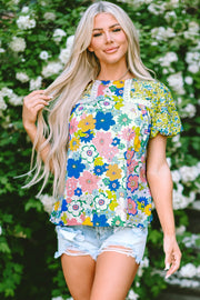 Floral patchwork puff sleeve blouse with lace trim and mixed floral prints.