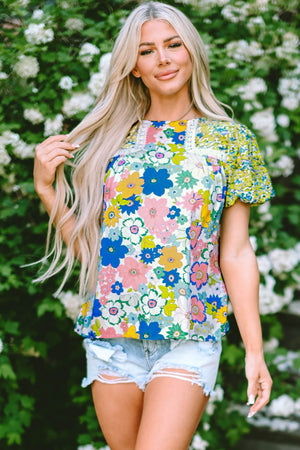 Floral patchwork puff sleeve blouse with lace trim and mixed floral prints.