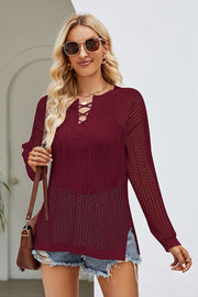 Burgundy lace-up openwork knit tunic with long sleeves and a V-neck.