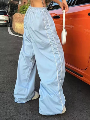 Light blue wide-leg maternity trousers with gathered waistband and white piping detail.