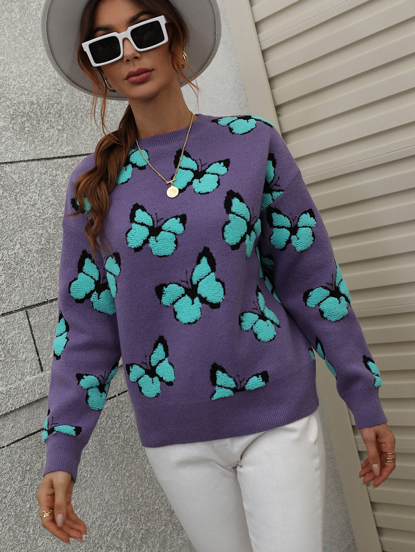 Purple knit crewneck sweater with allover turquoise butterfly motif
