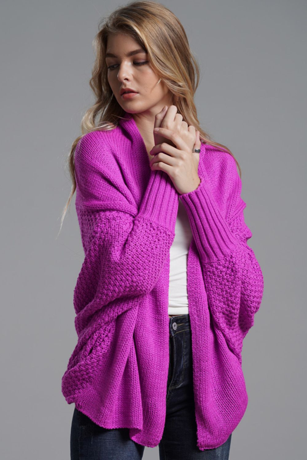 Fuchsia batwing knit cardigan with drape front and textured sleeves.