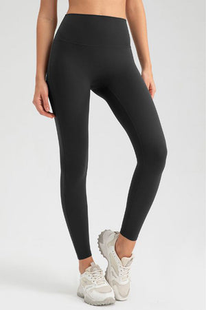 Black high-waist performance leggings with sculpting seams and a full-length cut.