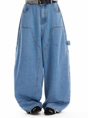 Classic wide-leg jeans in blue wash denim with angular pockets and a baggy fit.
