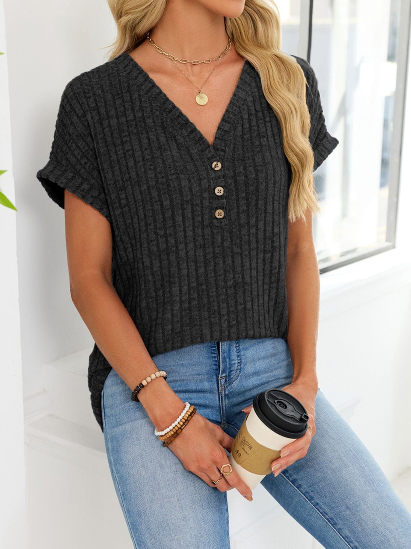 Black ribbed knit v-neck t-shirt with short sleeves and three button details