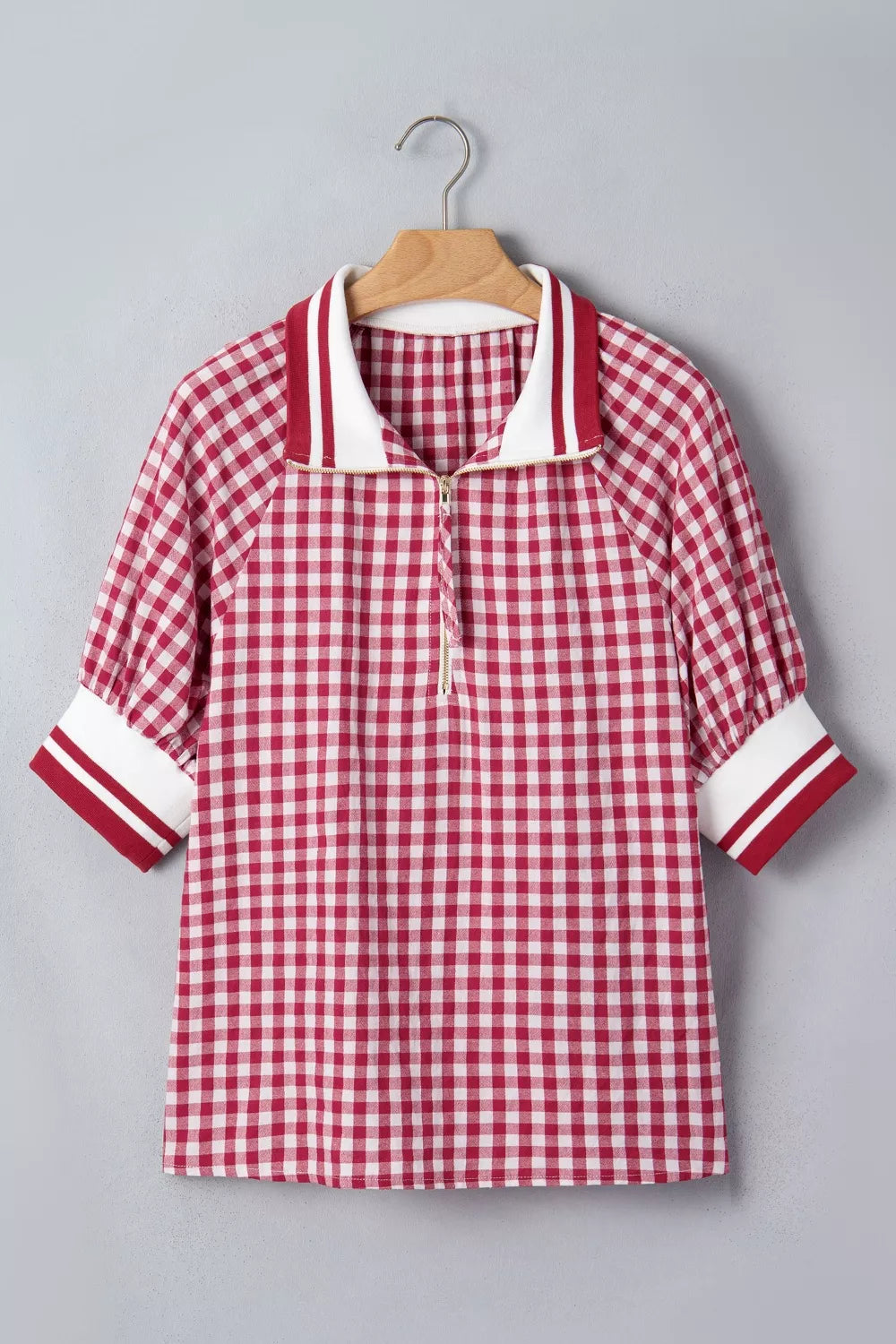 Red gingham cotton blend shirt with puff sleeves, zip collar, and striped cuffs.