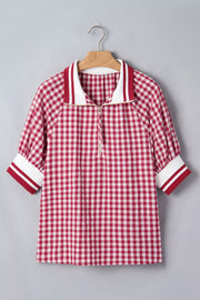 Red gingham cotton blend shirt with puff sleeves, zip collar, and striped cuffs.