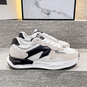 Panelled retro runner sneakers in beige, black, and white with mesh and suede details.