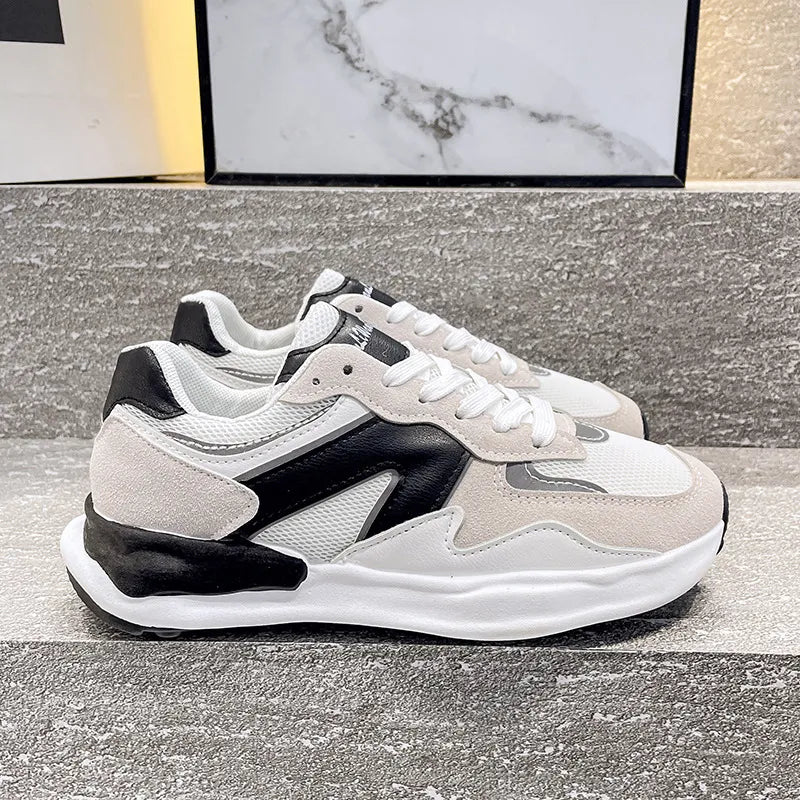 Panelled retro runner sneakers in beige, black, and white with mesh and suede details.