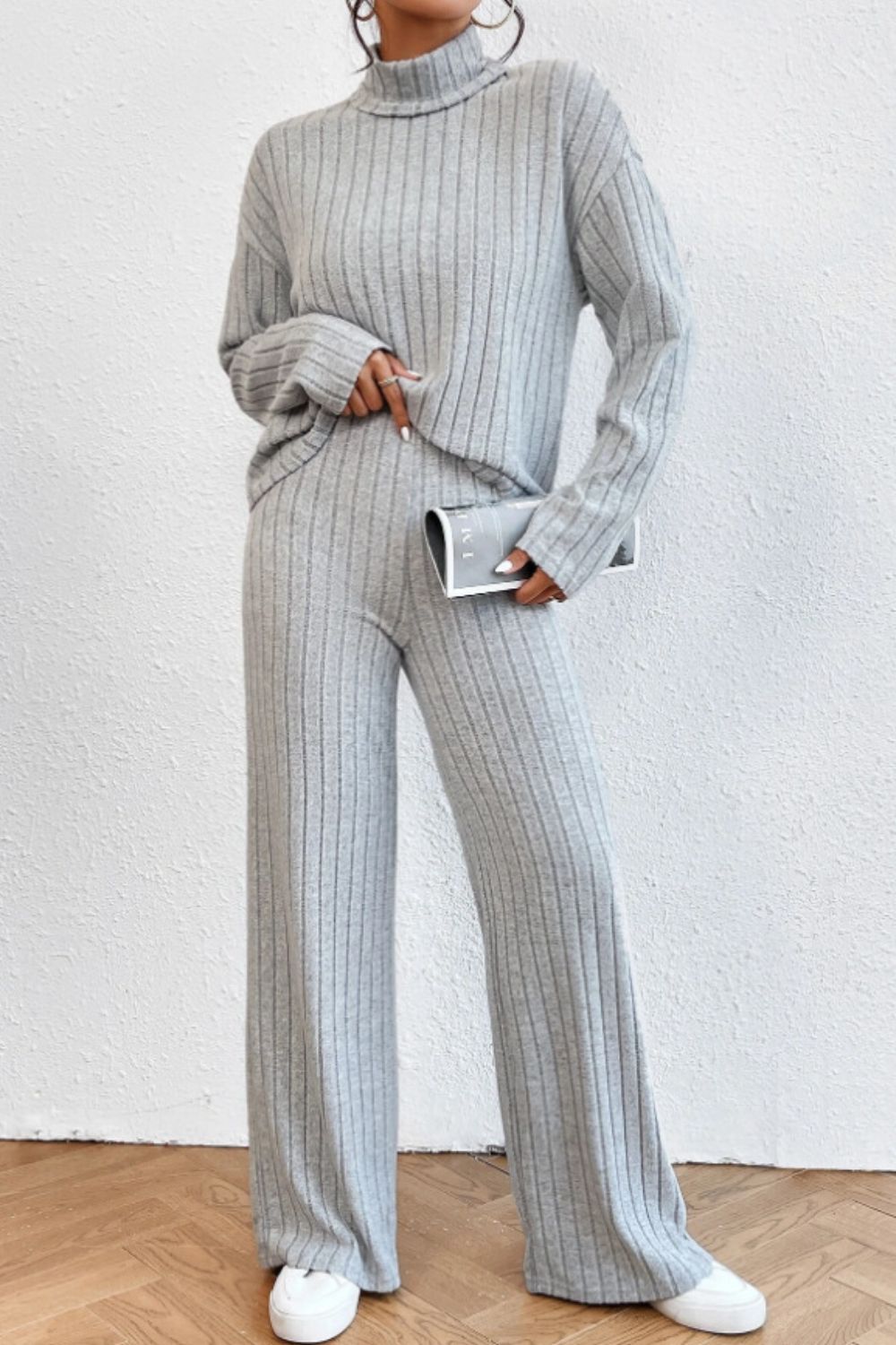 Light gray ribbed knit turtleneck loungewear set with wide leg pants.