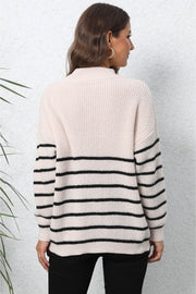 Beige striped knit sweater with black horizontal stripes on sleeves and lower body.