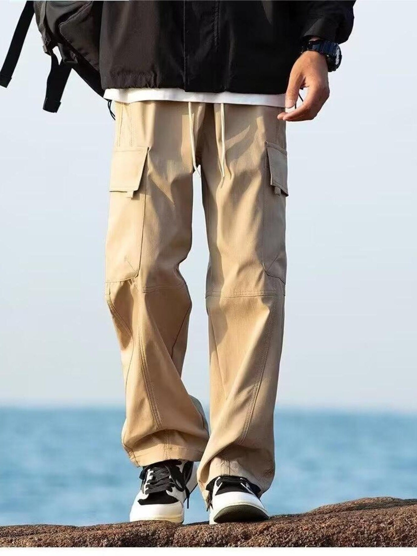 Khaki relaxed fit cargo pants with flap pockets and drawstring waist.