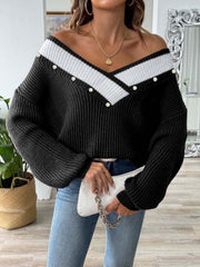 Black ribbed knit V-neck sweater with pearl trim and white stripe detail