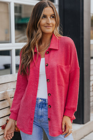 Waffle-knit oversized shirt jacket in strawberry pink with button-down front and chest pocket.