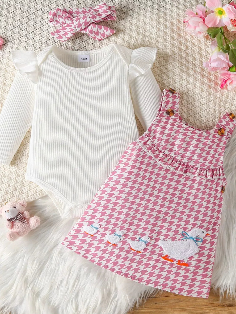 White ruffled long sleeve bodysuit with pink houndstooth duck dress and headband