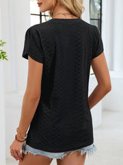 Black eyelet v-neck tee with petal short sleeves and textured fabric.