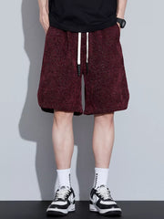 Burgundy textured drawstring shorts with a relaxed fit and white drawstrings.