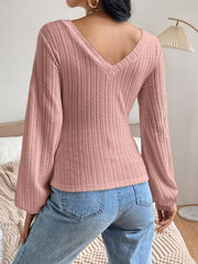 Textured chevron sleeve blouson top in dusty pink with a V-neck.