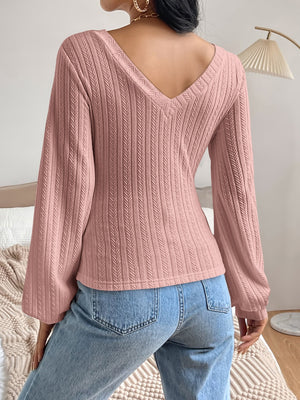 Textured chevron sleeve blouson top in dusty pink with a V-neck.