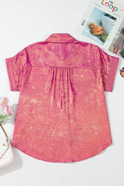 Dusty pink oversized button-down blouse with metallic finish and short sleeves.