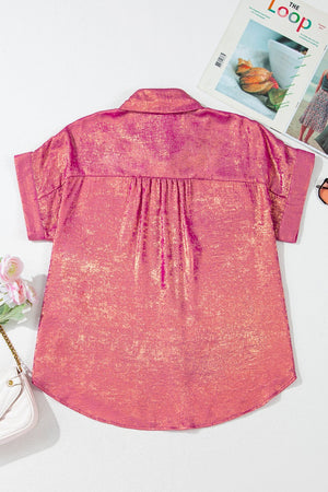 Dusty pink oversized button-down blouse with metallic finish and short sleeves.
