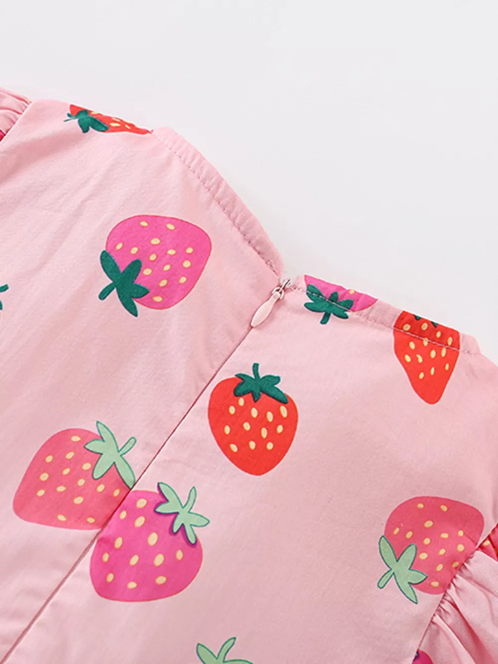 Pink cotton blend baby dress with strawberry print and puff sleeves.