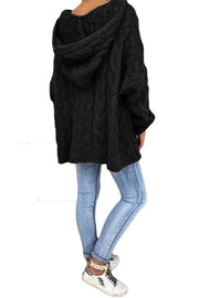 Black cable knit hooded cocoon sweater with a relaxed fit.