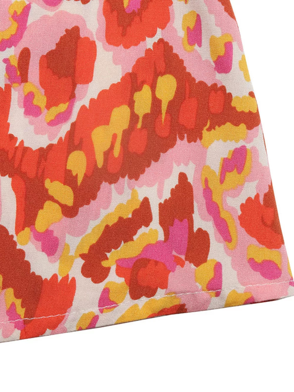 Abstract print maxi dress in pink, red, orange, and yellow.