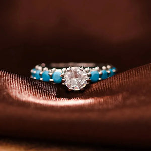 Sterling silver ring with solitaire diamond and turquoise bezel accents